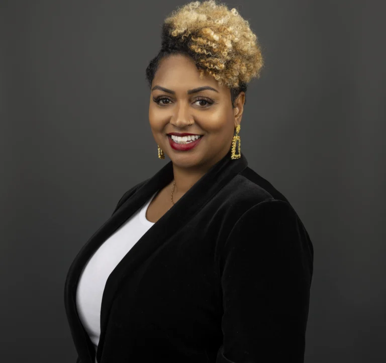 woman in business suit in front of a dark background