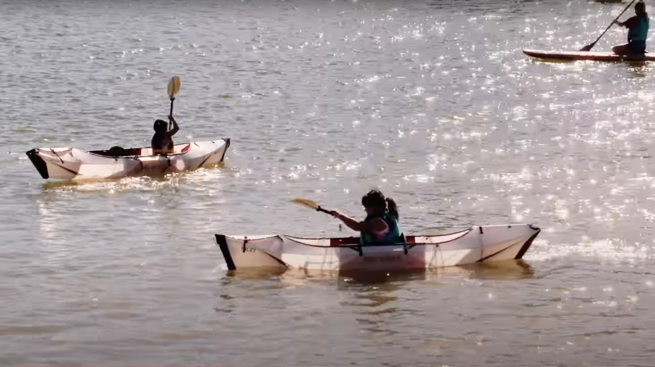 group of kids kayaking in a lake