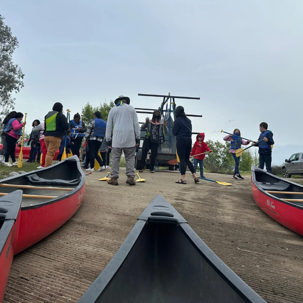 canoes and kids on a dock