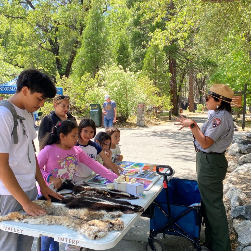 a park ranger giving lesson to group of kids at a table