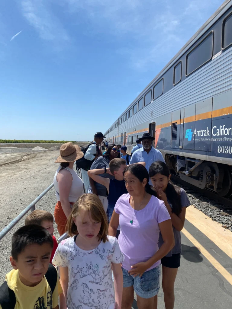 group of people leaving the train on blacktop area