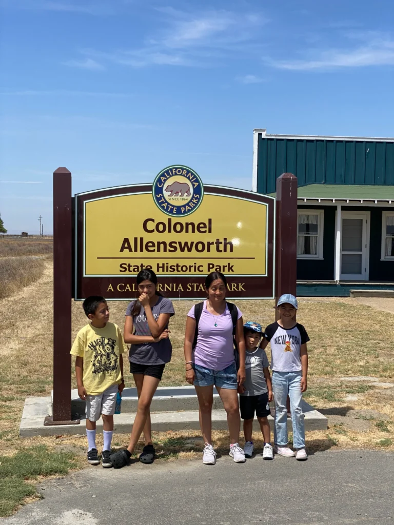 five kids standing in front of colonel allensworth historic park sign