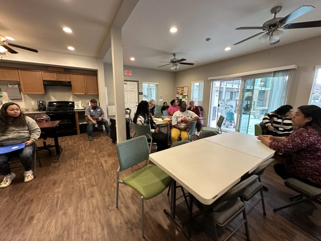 groups of people sitting around tables collaborating with each other