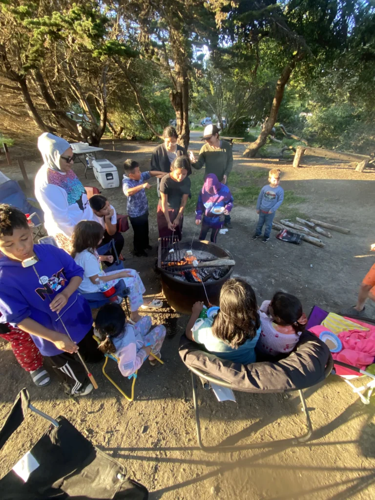 group of people at picnic site surrounded by trees